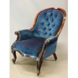 A VICTORIAN MAHOGANY SHOW FRAME HOOP BACKED ARMCHAIR BUTTON UPHOLSTERED IN DEEP BLUE VELVET, THE