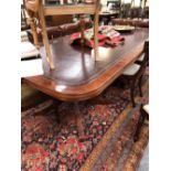 A MAHOGANY BOARD ROOM TABLE WITH LEATHER INSET ROUNDED RECTANGULAR TOP ON TWO BALUSTER COLUMNS, EACH