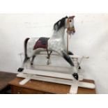 A SADDLED GREY ROCKING HORSE WITH BLACK DETAILS, HAIR MANE AND TAIL. W 153 x H 113cms.