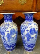 A PAIR OF JAPANESE BLUE AND WHITE BALUSTER VASES, EACH PAINTED WITH TWO RESERVES OF THREE FIGURES ON