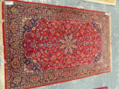 A PERSIAN KASHAN RUG. 216 x 142cms