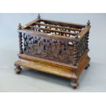 A VICTORIAN WALNUT THREE COMPARTMENT CANTERBURY WITH PIERCED SCROLL SIDES ABOVE A DRAWER AND THE