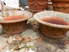 A NEAR PAIR OF SHALLOW TERRACOTTA PLANTERS WITH LATTICE DECORATION DIAMETER 56cm AND 52 cms