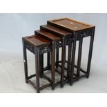 A NEST OF FOUR CHINESE HARDWOOD TABLES, EACH WITH APRONS PIERCED AND CARVED WITH DRAGONS