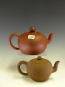 A CHINESE YIXING RED WARE TEA POT BEARING SEAL MARKS INSIDE THE COVER AND ON THE FOOT. Dia 15cms.