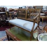 A NEO CLASSICAL STYLE GILT WOOD SETTEE, THE TWO DIVISION BAR BACK WITH CENTRAL ROSETTES, THE UPHOL