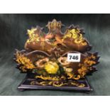 A VICTORIAN PAPIER MACHE LETTER RACK PAINTED WITH FLOWERS AND A BIRD AMONGST GILT FOLIAGE