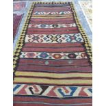 AN ANTIQUE PERSIAN TRIBAL KELIM RUNNER. 326 x 164cms