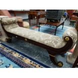 AN EMPIRE STYLE MAHOGANY FRAMED WINDOW SEAT WITH CARVED AND GILDED DECORATION. H 68 X W 174 X D