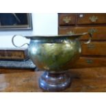 AN ARTS AND CRAFTS COPPER AND BRASS TWO HANDLED URN
