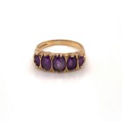 A 9ct HALLMARKED GOLD FIVE STONE GRADUATED AMETHYST CARVED HOOP RING. FINGER SIZE M. WEIGHT 2.