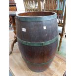 A LARGE COOPERED OAK BARREL.