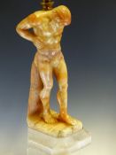 A TWO TONE ALABASTER LAMP CARVED AS A FIGURE OF ATLAS SUPPORTING A GLOBE SHADE ON HIS SHOULDERS,