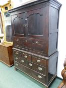 AN 18th/19th C. WELSH OAK CABINET WITH THE TWO DOORS TO THE TOP WITH SERPENTINE TOPPED PANELS OVER A
