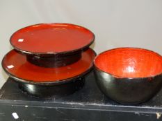TWO JAPANESE LACQUER STANDING DISHES WITH CIRCULAR RED TOPS AND WITH BLACK RIMS AND FLARED