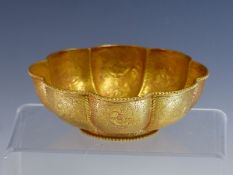 A CHINESE OCTAFOIL SILVER GILT BOWL, THE EXTERIOR WORKED WITH BIRD CENTRED PANELS, A ROUNDEL OF