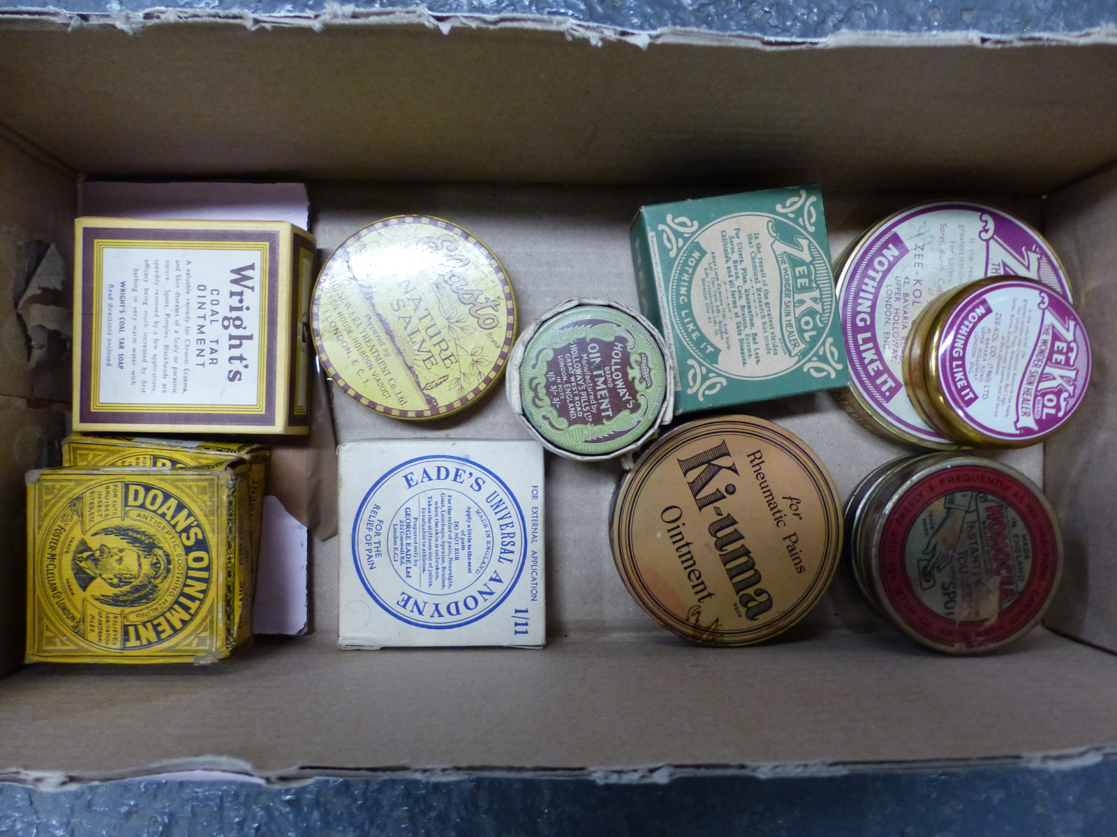 A COLLECTION OF PACKAGES AND TINS OF OINTMENTS