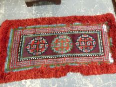 FOUR TRIBAL RUGS, POSSIBLY TIBETAN. LARGEST 185 x 88cms (4)