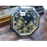 AN OCTAGONAL CHINOISERIE DECORATED DESK CLOCK WITH EASEL BACK