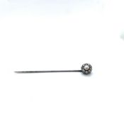 AN ANTIQUE PEARL AND DIAMOND STICK PIN. THE HEAD OF A SILVER CROWN FORM ON A STEEL PIN. HEAD