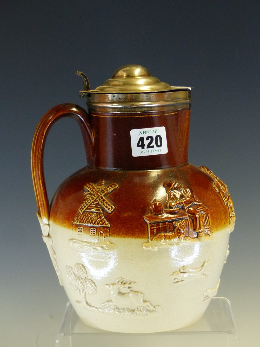 A SILVER LIDDED TWO TONE SALTGLAZE JUG SPRIGGED WITH FIGURES AND A WINDMILL ABOVE A STAG HUNT