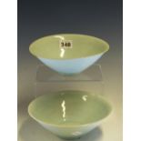 TWO QINGBAI BOWLS, BOTH INCISED WITH TWO FISH SWIMMING IN COMBED WATER. Dia. 18cms. WITH A CLOTH