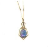 AN EARLY 20th CENTURY OPAL AND GARNET OPEN WORK ART DECO STYLE PENDANT, SUSPENDED ON A FANCY LINK