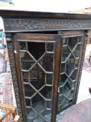 A LATE VICTORIAN OAK DISPLAY CABINET ON SINGLE DRAWER STAND WITH GEOMETRIC BLIND FRET BANDS ABOUT