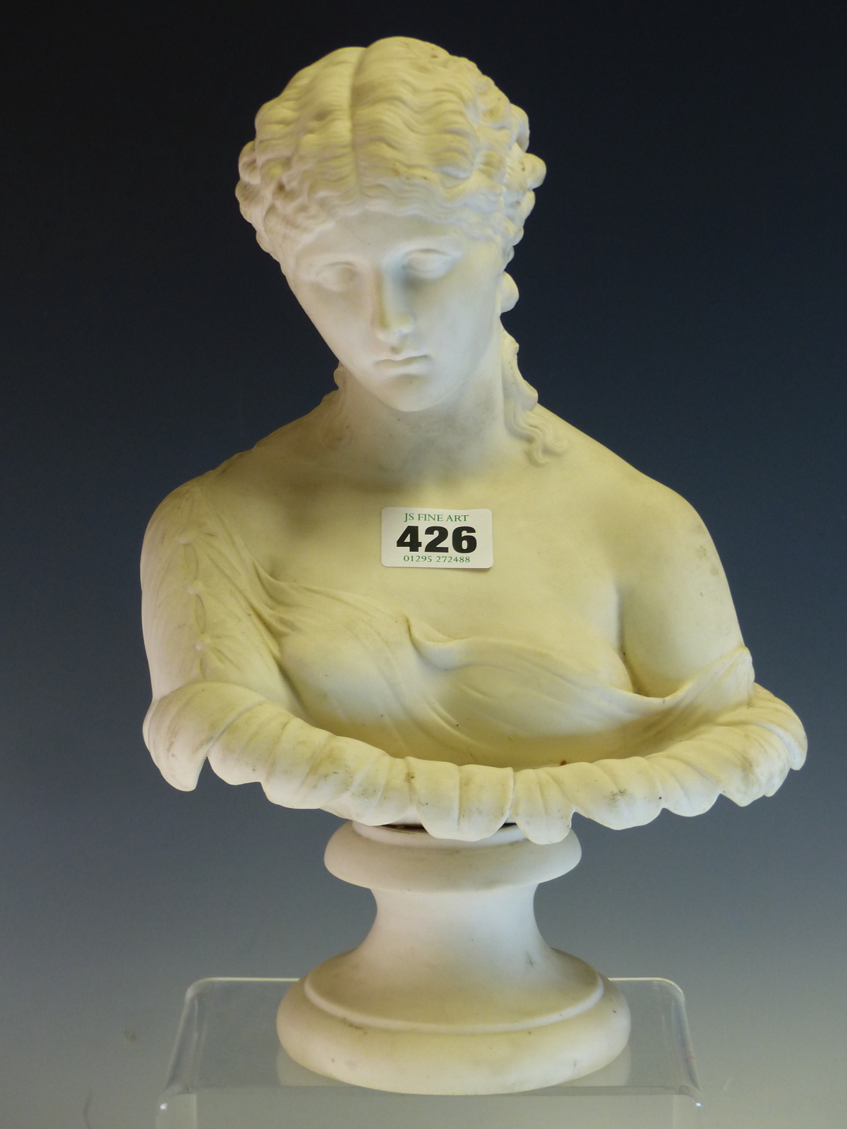 A MID VICTORIAN PARIAN BUST OF THE CLYTIE ON A SOCLE FOOT. H 29cms.