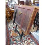 A LATE VICTORIAN LEATHER MOUNTED FOLIO STAND ON EBONISED LEGS. W 97 x 66.5 x H 116cms.