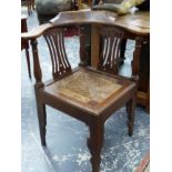 A 19th CENTURY OAK CORNER ARM CHAIR WITH SILHOUETTE LEGS.