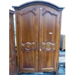 A LARGE EARLY 19th CENTURY FRENCH PROVINCIAL WALNUT TWO DOOR ARMOIRE. H 223 X W 140 X D 57cms.