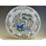 AN 18th C. DUTCH DELFT POLYCHROME DISH PAINTED WITH A CENTRAL PALM TREE FLANKED BY FLOWERS, AK