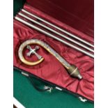 A CASED THREE PIECE CROZIER, THE GILT HEAD WORKED WITH SILVERED LEAVES WITH A CROSS WITHIN THE