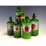 SIX RIBBED CYLINDRICAL GREEN GLASS PHARMACY BOTTLES AND STOPPERS LABELLED: ANTIME ARTARAT:, TINCT