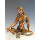 A NEPALESE COPPER FIGURE OF A SEATED LADY WEARING ROSETTE EARINGS, BRACELETS AND