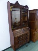 AN ARTS AND CRAFTS OAK BUREAU BOOKCASE, THE UPPER HALF WITH GLAZED DOORS, THE BASE WITH THE FALL