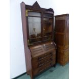 AN ARTS AND CRAFTS OAK BUREAU BOOKCASE, THE UPPER HALF WITH GLAZED DOORS, THE BASE WITH THE FALL