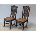 A PAIR OF CHINESE HARDWOOD SIDE CHAIRS, THE TOP RAILS PIERCED AND CARVED WITH SQUIRRELS AMONGST