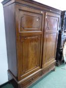 A 19th C. MAHOGANY WARDROBE, THE CAVETTO CORNICE ABOVE PANELLED DOORS OVER TWO SHORT DRAWERS AND