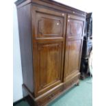 A 19th C. MAHOGANY WARDROBE, THE CAVETTO CORNICE ABOVE PANELLED DOORS OVER TWO SHORT DRAWERS AND