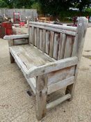 A LARGE WEATHERED HARD WOOD SETTLE WITH PANELED BACK W 183 x D 70 x H 107 cms