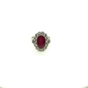 A RUBY AND DIAMOND EDWARDIAN STYLE OVAL CLUSTER RING. UNHALLMARKED, ASSESSED AS PLATINUM. FINGER