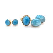 A TURQUOISE OVAL CABOCHON RING TOGETHER WITH TWO PAIRS OF SIMILAR EARRINGS. UNHALLMARKED, THE LARGER