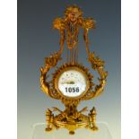 AN ORMOLU LYRE CLOCK, THE MASK TOP FLANKED BY COCKEREL HEADS, THE PLATFORM ESCAPEMENT MOVEMENT