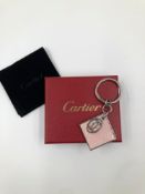A CARTIER KEY RING, COMPLETE WITH BOX AND POUCH. REF NUM: T1220343,