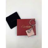 A CARTIER KEY RING, COMPLETE WITH BOX AND POUCH. REF NUM: T1220343,