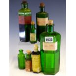 SEVEN HEXAGONAL GREEN GLASS PHARMACY BOTTLES VARIOUSLY PAPER LABELLED: OIL OF MUSTARD, BATTERY ACID,