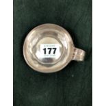 A FRENCH SILVER TASTEVIN, DISCHARGE MARKS, WITH A REEDED RING HANDLE, 59gms. Dia. 7.25cms.