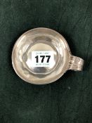 A FRENCH SILVER TASTEVIN, DISCHARGE MARKS, WITH A REEDED RING HANDLE, 59gms. Dia. 7.25cms.